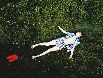 High angle view of man sleeping on grass