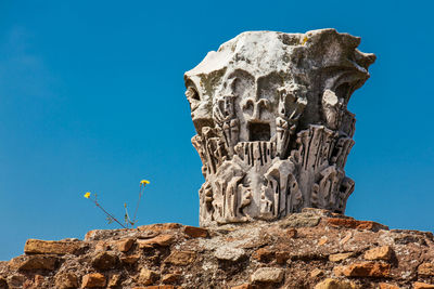 Low angle view of statue against clear blue sky