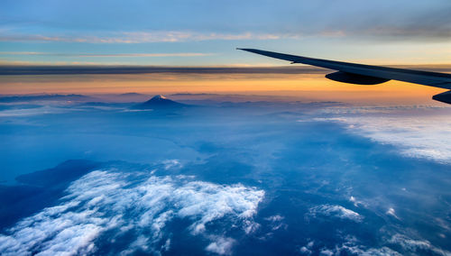 Aerial view of sea against sky during sunset