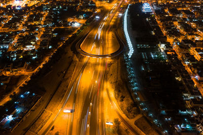High angle view of light trails on city street amidst buildings