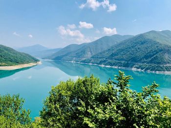 Scenic view of lake and mountains against sky