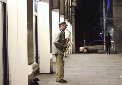 Full length portrait of young man standing in city