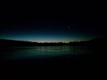 Scenic view of silhouette landscape against sky at night