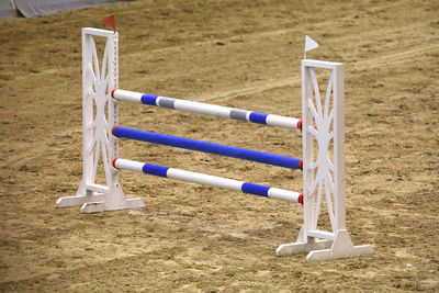 Close-up of deck chairs on field