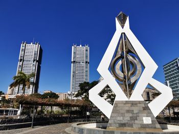 Low angle view of modern building against clear blue sky