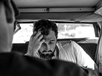 Midsection of man sitting in car