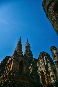 Low angle view of temple against clear blue sky