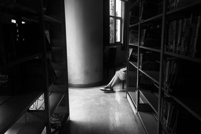 Woman sitting on staircase in building