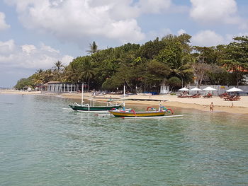 Boats moored on sea against sky