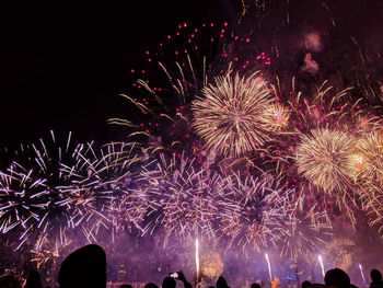 Low angle view of firework display at night