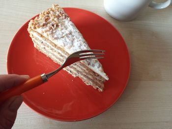 Close-up of hand holding cake