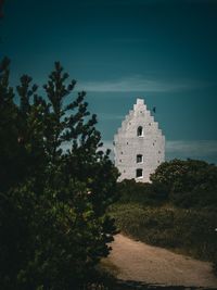 Trees and buildings against sky