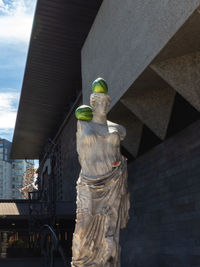 Low angle view of statue against building