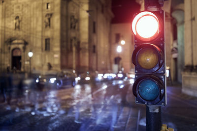 Illuminated street light on road at night