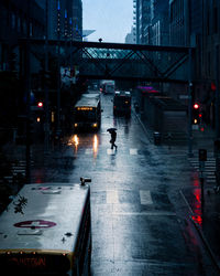 Cars moving on wet street in rainy season at night