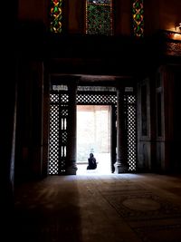 Woman sitting outside building