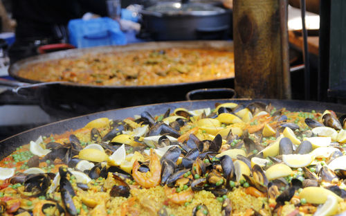 Seafood paella cooking in a big pan at borough market, london, uk
