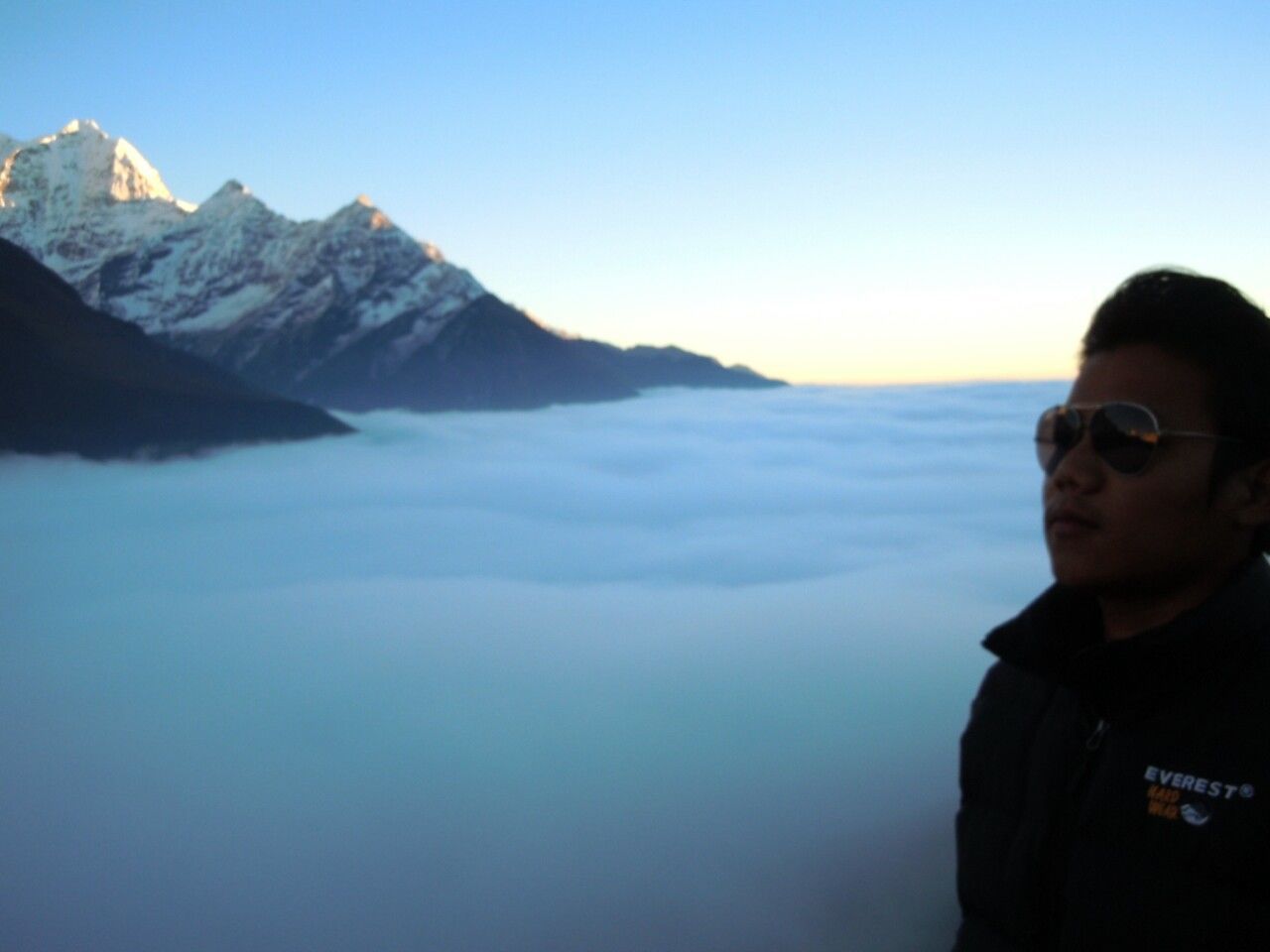 lifestyles, mountain, leisure activity, young adult, clear sky, young men, copy space, person, headshot, scenics, water, tranquility, beauty in nature, portrait, tranquil scene, mountain range, looking at camera, vacations