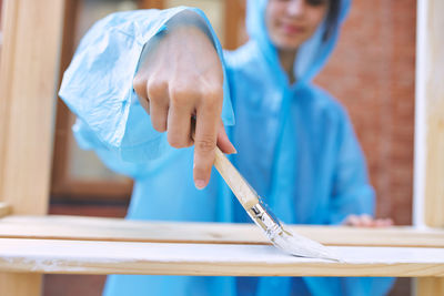 Midsection of man working in workshop