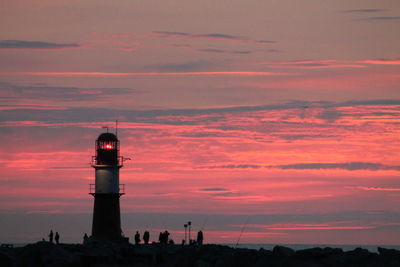 Silhouette of lighthouse at sunset