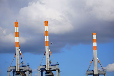 Low angle view of crane against sky