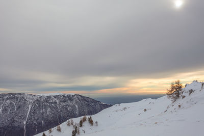 Snowy slope with mount pizzoc and venetian lagoon in the background, col visentin, belluno, italy