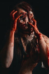 Portrait of human face against black background