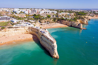 High angle view of sea and buildings against sky