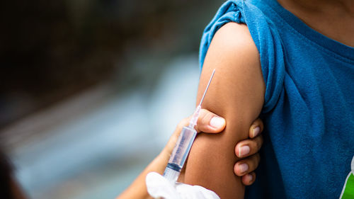 Close-up of doctor giving injection to patient