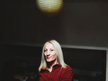 Portrait of senior woman standing in darkroom