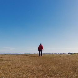 Rear view of woman standing on landscape