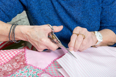 Close-up of woman cutting fabric