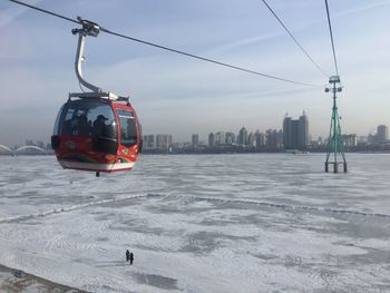 Overhead cable cars over snow covered city
