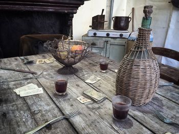 Drinks and wicker jar on wooden table