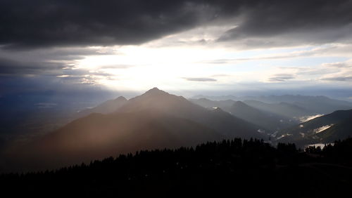 Scenic view of silhouette mountains against sky during sunset