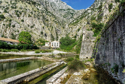 Panoramic view of canal amidst buildings against sky