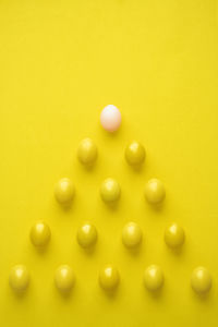 High angle view of candies on table against yellow background