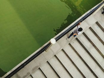 High angle view of boy walking on footbridge 