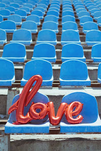 Love text on chair at stadium