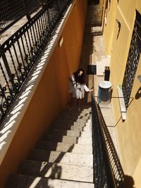 High angle view of woman standing on staircase