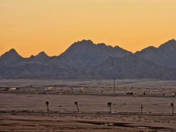 Scenic view of desert against sky during sunset