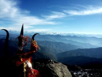 Trident by mountains against sky