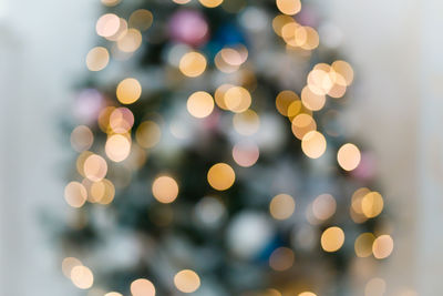 Defocused image of illuminated christmas lights at night