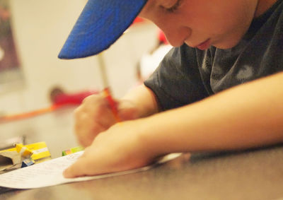 Close-up of boy drawing in school