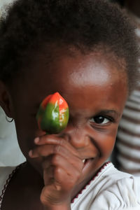 Close-up portrait of boy holding fruit