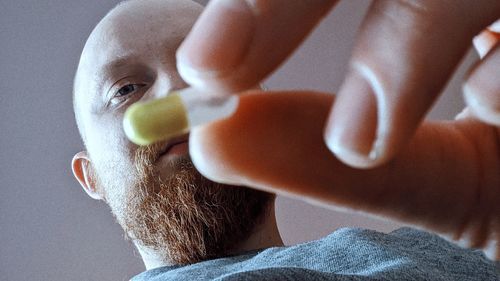 Close-up of man holding fruit