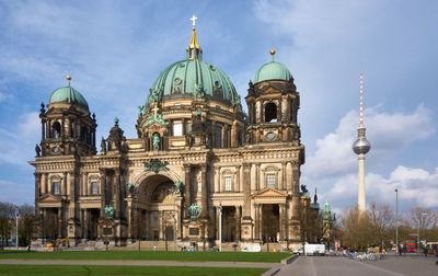 Cathedral by fernsehturm in city against sky