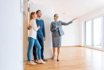 Friends standing on hardwood floor