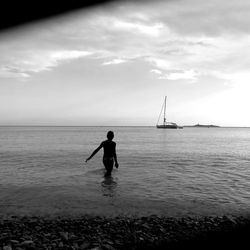 Silhouette people on calm beach