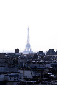 Buildings in city against clear sky